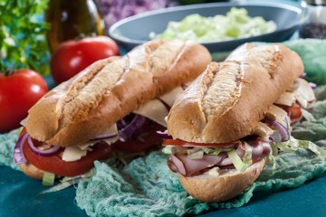 Submarine sandwiches with ham, cheese and vegetables