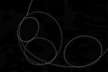 Round shapes of stretched metal springs on black background surface