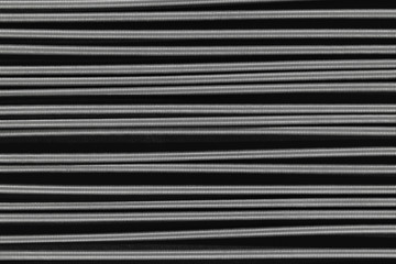Metal springs placed horizontally on black background surface