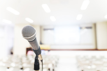 Fototapeta premium Microphone over the blurred business forum Meeting or Conference Training Learning Coaching Room Concept, Blurred background