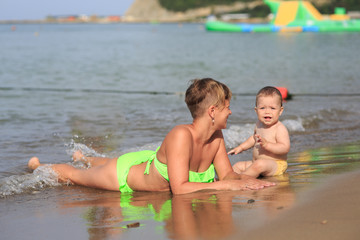 Mom with a baby on the sea
