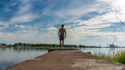 Young man standing on a jetty in Kalmar, Sweden © DZiegler