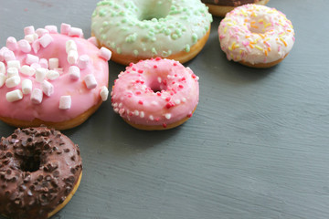 Photos of different donuts. Assorted colorful donuts in glaze close-up.