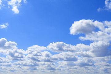 White clouds in bright blue sky (background)