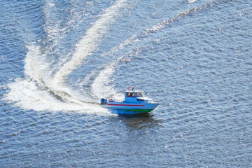 Fototapeta premium Motor boat moves on the water