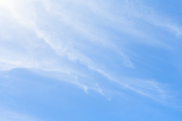 Fototapeta premium White feather clouds in azure sky as background