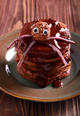 Halloween chocolate pancakes served with glaze