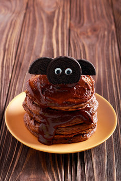 Halloween chocolate pancakes served with glaze