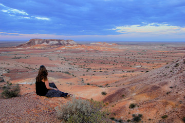 Young girls or women with brown hair looking over the desert near Coober Pedy in the Southern...