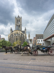 Naklejka na ściany i meble Horse carriage and St. Nicholas church in center of Gent, Belgium