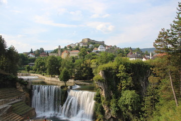 Fototapeta na wymiar Jajce Waterfall in Jajce impressive 21m-high waterfalls form where the Pliva River tumbles abruptly into the Vrbas Rivers.