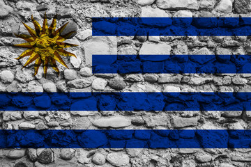 Fototapeta na wymiar Flag of Uruguay on pebble wall
