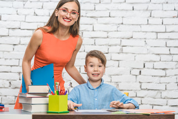 Teacher woman and school student looking at the camera