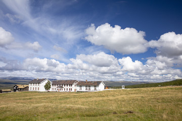 Clouds over a old farm at Dovre Mountain in Norway