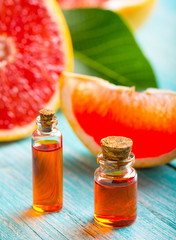citrus oil cosmetic grapefruit medicine health nature glass vial wooden background
