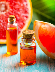 citrus oil cosmetic grapefruit medicine health nature glass vial wooden background
