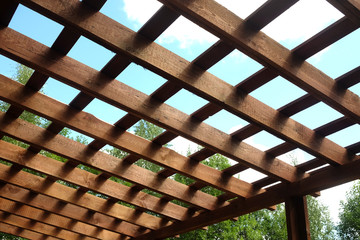 Top of brown wooden pergola on sunny summer day side view outdoor