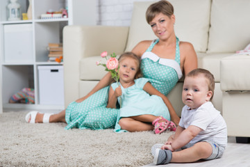 mom with two children playing at home in the room