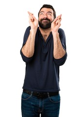 Handsome man with beard with his fingers crossing