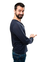 Fototapeta premium Handsome man with beard presenting something