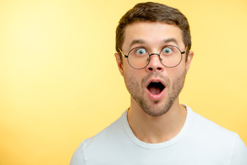 astonished guy looking at the camera. emotional man with wide open eyes. unbelievable opportunities for students