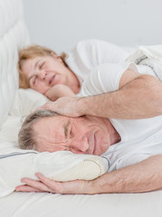 senior man who can not sleep because his wife snores