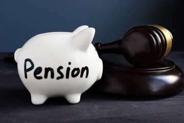 Gavel and piggy bank with sign pension. Legal and law concept.