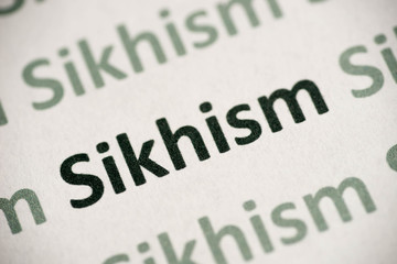 word Sikhism printed on paper macro