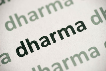 Fototapeta premium word dharma printed on paper macro