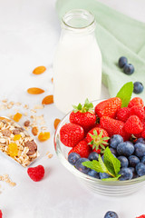 Homemade granola or oatmeal muesli with nuts, dried fruits and fresh berries. Healty diet breakfast, vegeterian food concept