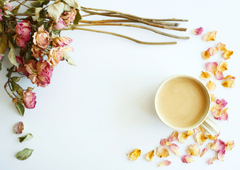 Picture of autumn background with dry roses and cup of coffee with copy space over white background