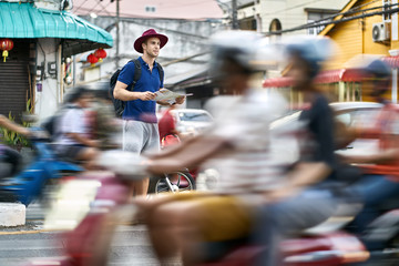 Traveler on asian city street. Daylight shooting.