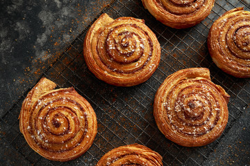Freshly baked cinnamon swirls with icing sugar