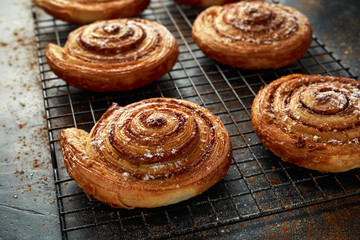 Freshly baked cinnamon swirls with icing sugar