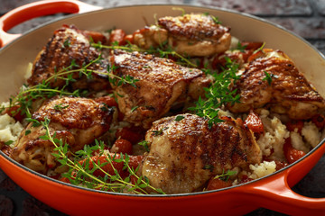 Free range chicken thighs with rice and honey glazed chantenay carrots in pan