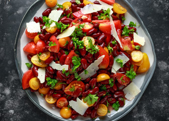 Healthy Red beans and mix of organic red and yellow pear shaped, beef heart and cherry tomatoes salad with picorino romano cheese shavings topped with parsley