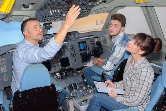 Students with instructor in aircraft cockpit