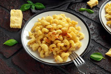 Homemade baked macaroni and cheese with cheddar served on plate