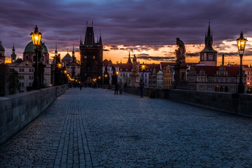 View of the Lesser Bridge Tower of Charles Bridge in Prague at sunrise, Czech Republic, Europe. This bridge is the oldest in the city and a very popular tourist attraction.