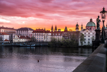 Fototapeta na wymiar Romantic views of Prague from Charles Bridge at sunrise