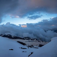 Clouds above Baksan valley from snow covered Elbrus slope