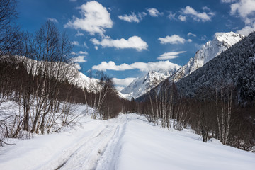 Fototapeta na wymiar A road in the winter Caucasus mountains. Alibek, Dombai, Russia.