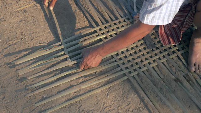 Weaving baby cradle with bamboo laths ( extreme close up)