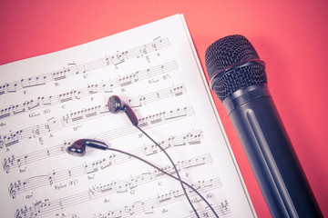 Microphone on music sheets. The concept of creating music.