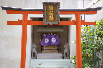 Shinto neighborhood sanctuary with torii portal dedicated to Inari fox deity in Komagome's Somei...