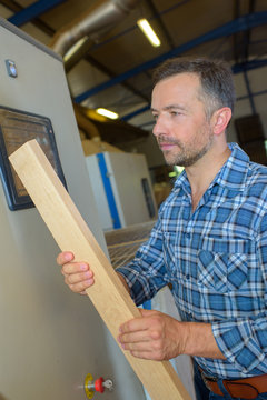 Man holding plank of wood