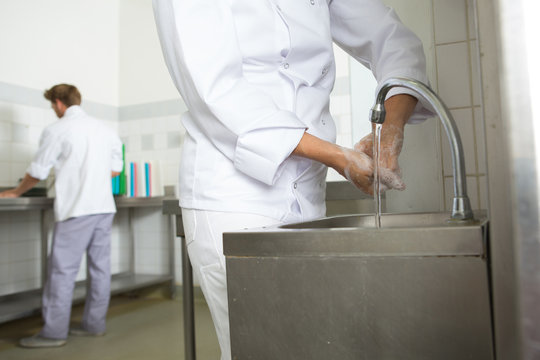 kitchen worker washing hands