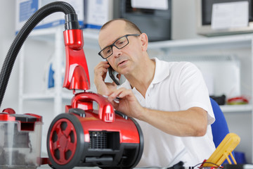 male repairing vacuum cleaner