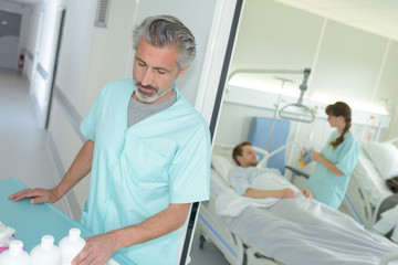 Fototapeta premium portrait of young male nurse in scrubs at clinic