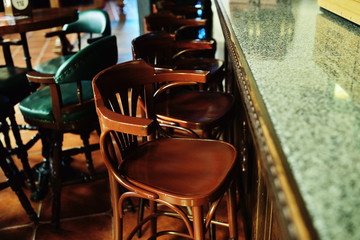 wooden chair in the pub on the background of the bar